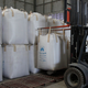 A worker in Thailand lifts a giant bulk sack, called a super sack, of rice with a forklift.